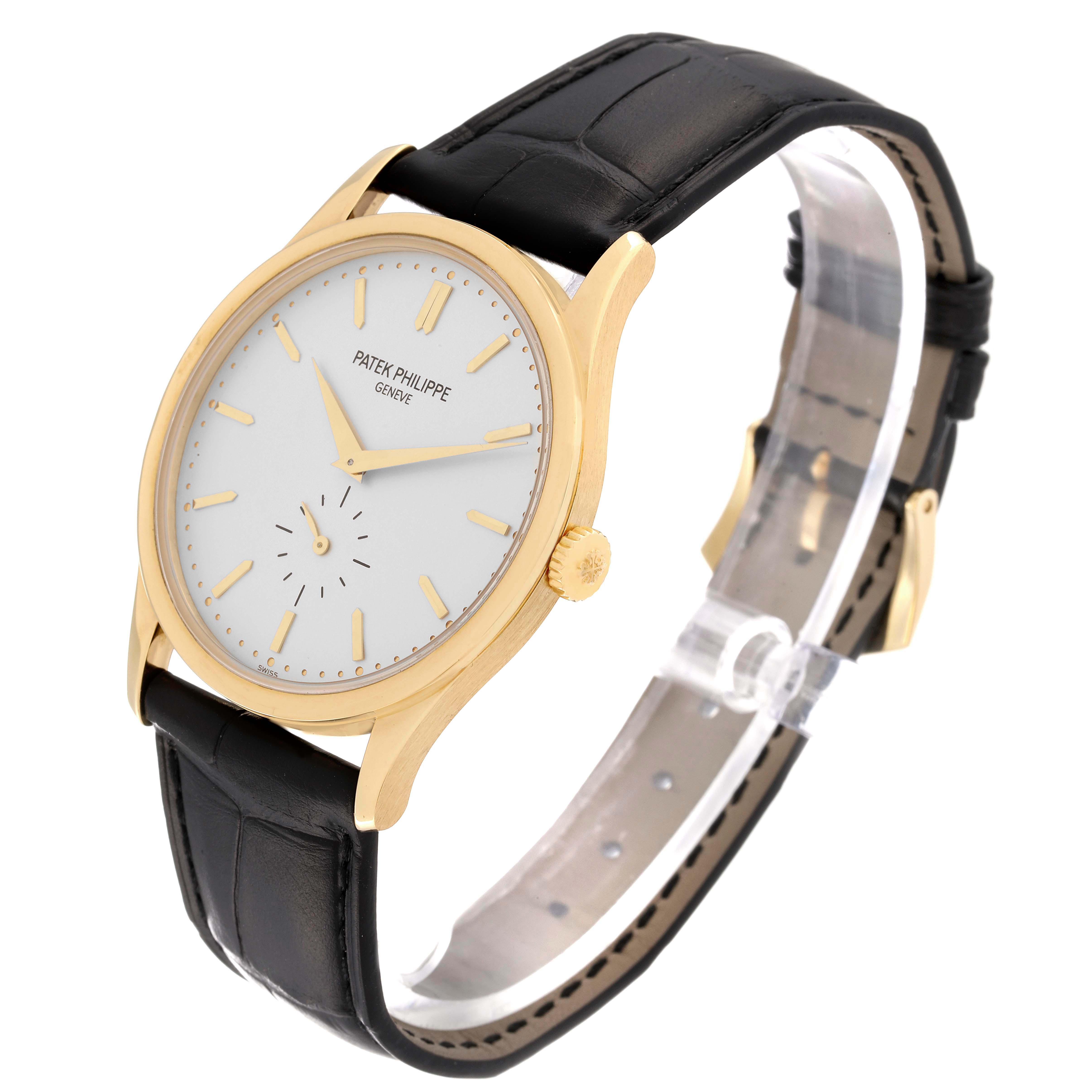 The image shows a Patek Philippe Calatrava 5196J Men's Yellow Gold Silver Dial 5196J Men's Yellow Gold Silver Dial watch from a front angle, highlighting its face, case, and leather strap.