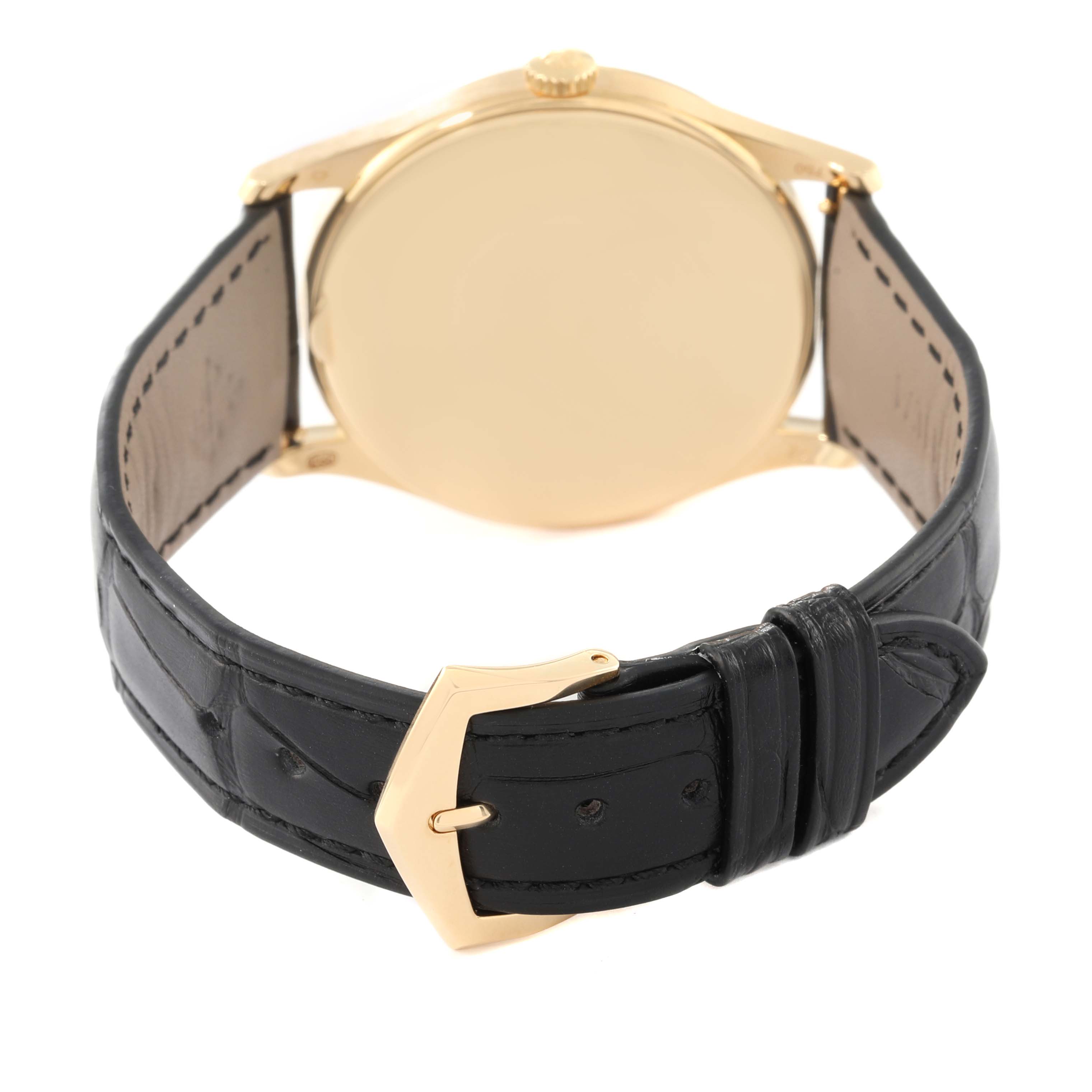 This image shows the back view of a Patek Philippe Calatrava 5196J Men's Yellow Gold Silver Dial 5196J Men's Yellow Gold Silver Dial watch, highlighting its case, crown, and leather strap with a buckle.