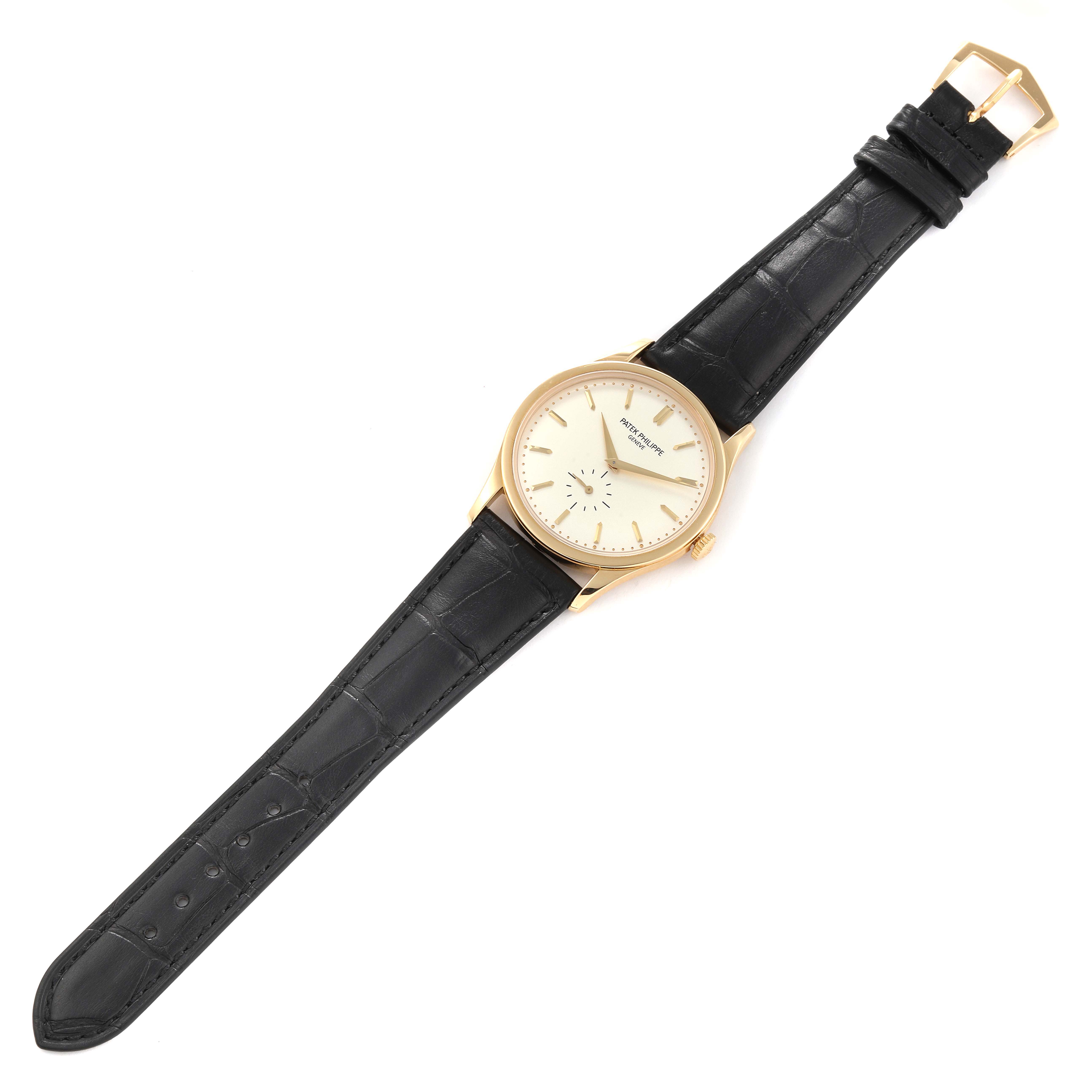 The Patek Philippe Calatrava 5196J Men's Yellow Gold Silver Dial 5196J Men's Yellow Gold Silver Dial watch is displayed flat from a top-down angle, showcasing the dial, case, and leather strap.