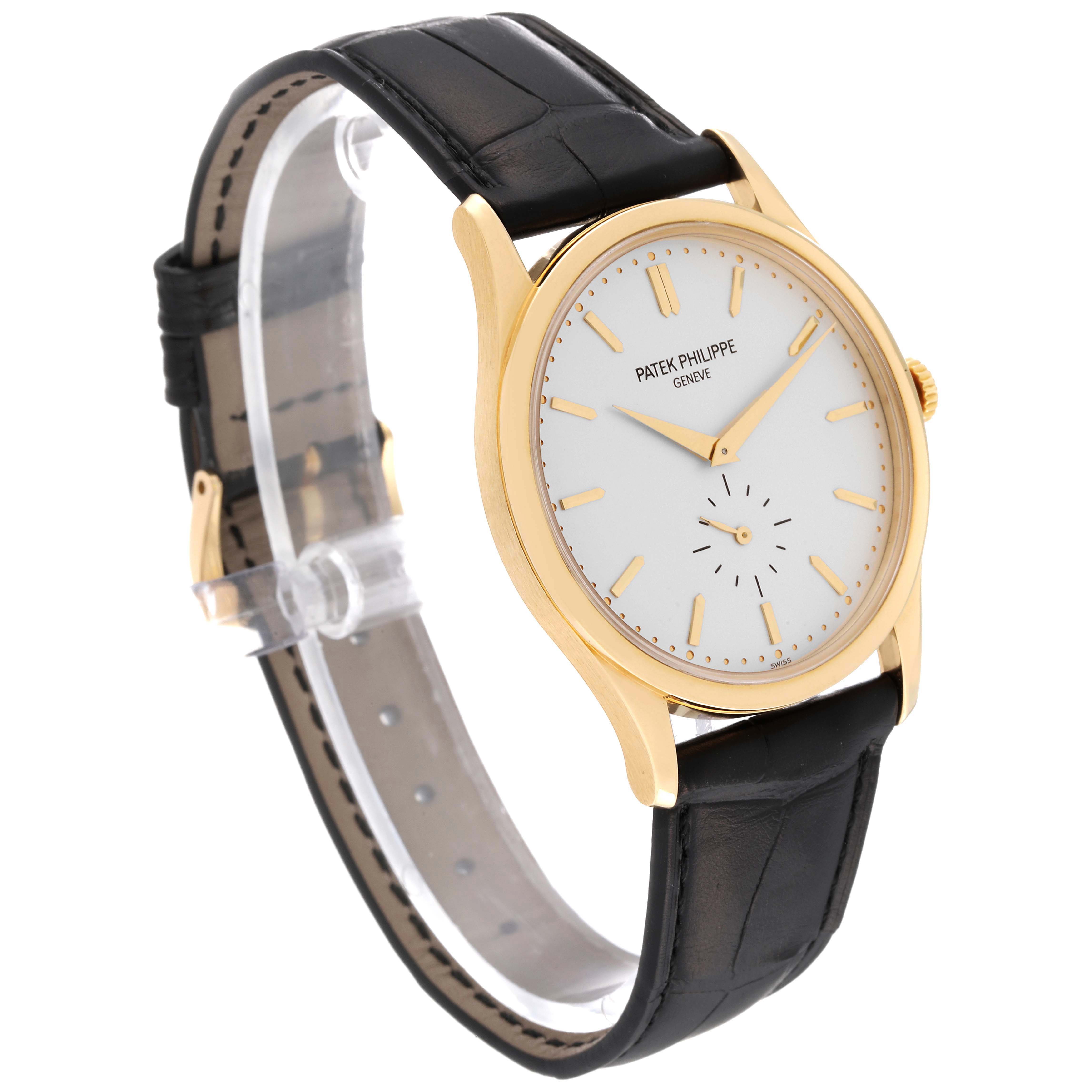 The Calatrava model by Patek Philippe is shown at a three-quarter angle featuring the dial, gold case, and black leather strap.