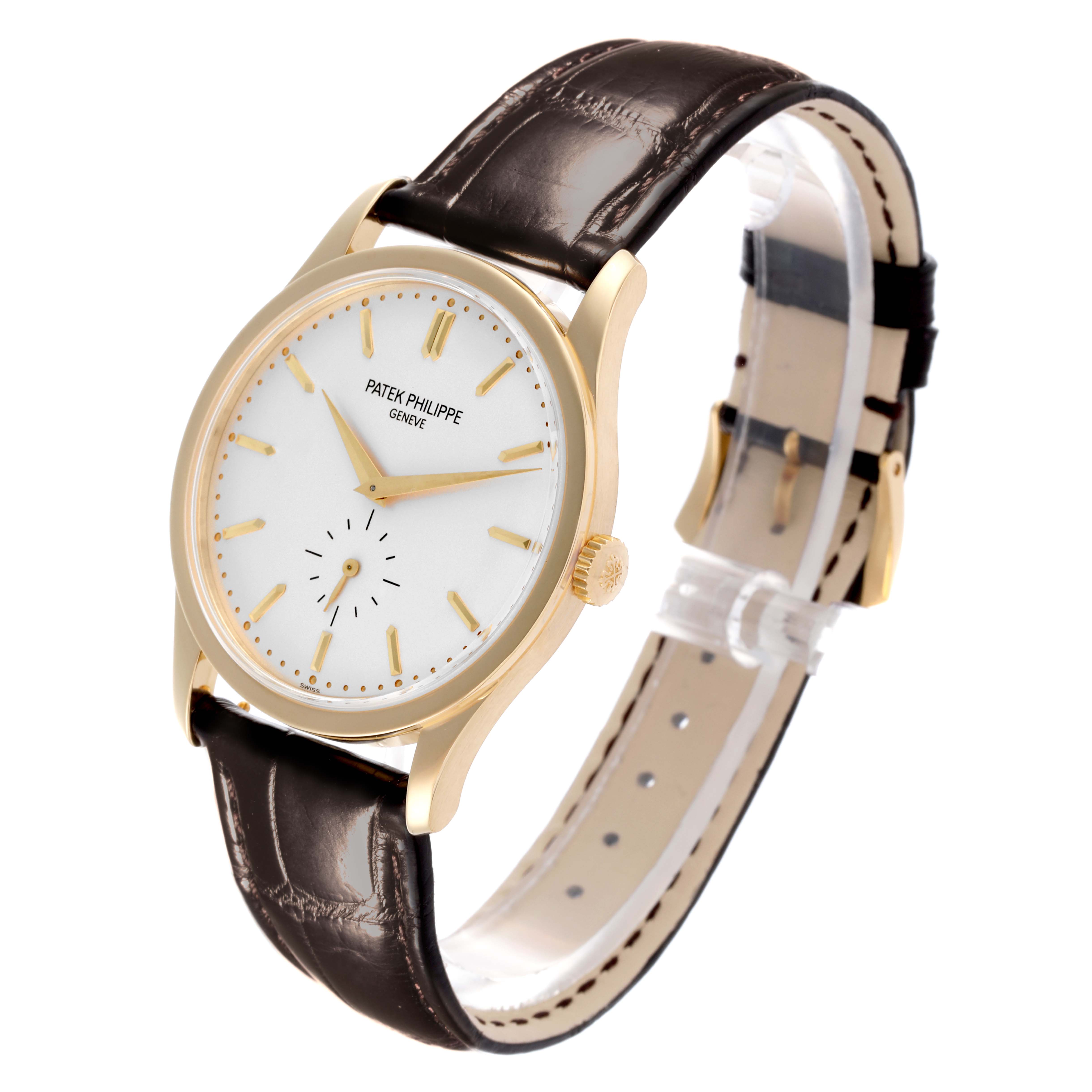 The Patek Philippe Calatrava 5196J Men's Yellow Gold Silver Dial 5196J Men's Yellow Gold Silver Dial watch is shown from a semi-side angle, displaying the face, case, crown, and leather strap.