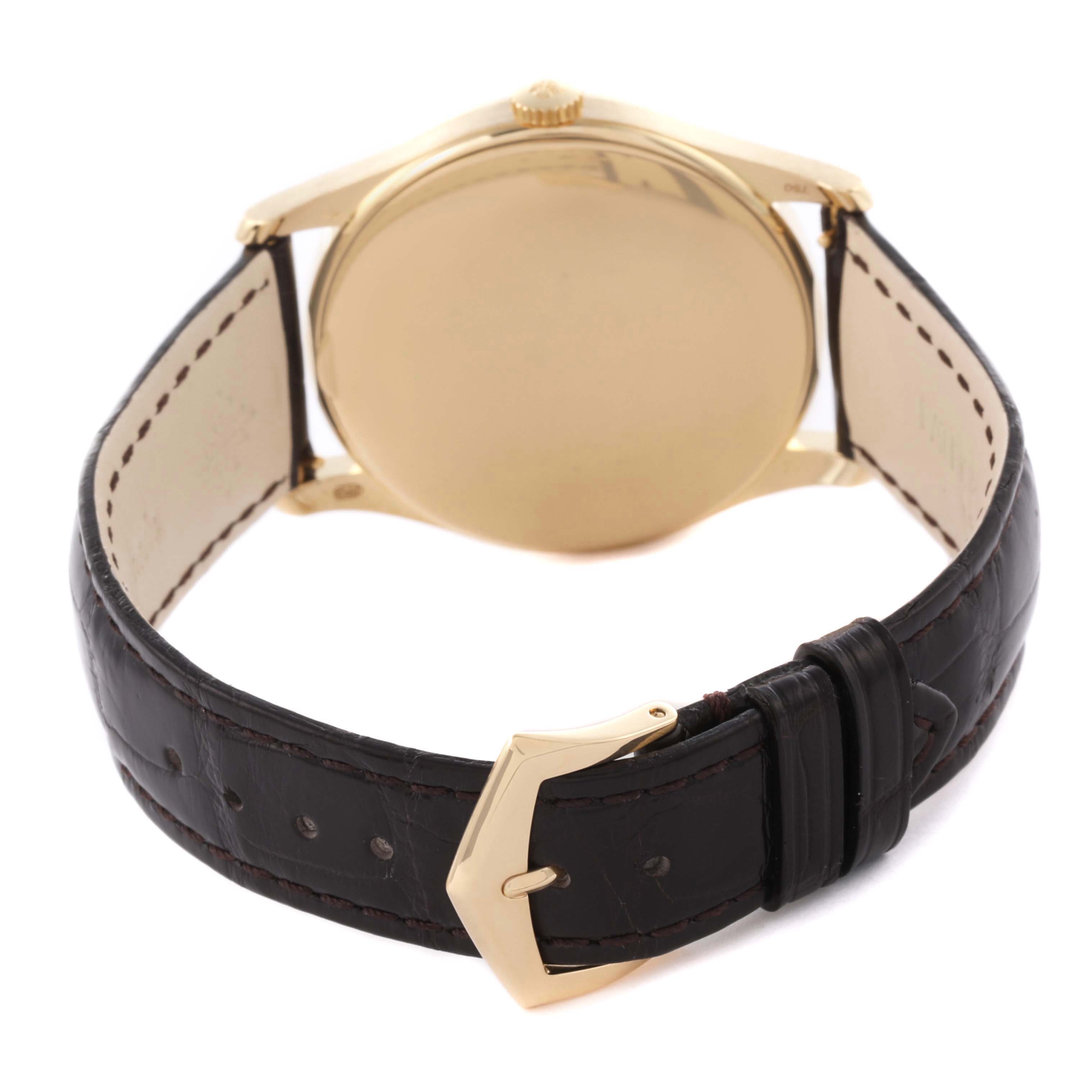 The image shows a Patek Philippe Calatrava 5196J Men's Yellow Gold Silver Dial 5196J Men's Yellow Gold Silver Dial watch from the back, displaying the case back, strap, and buckle.