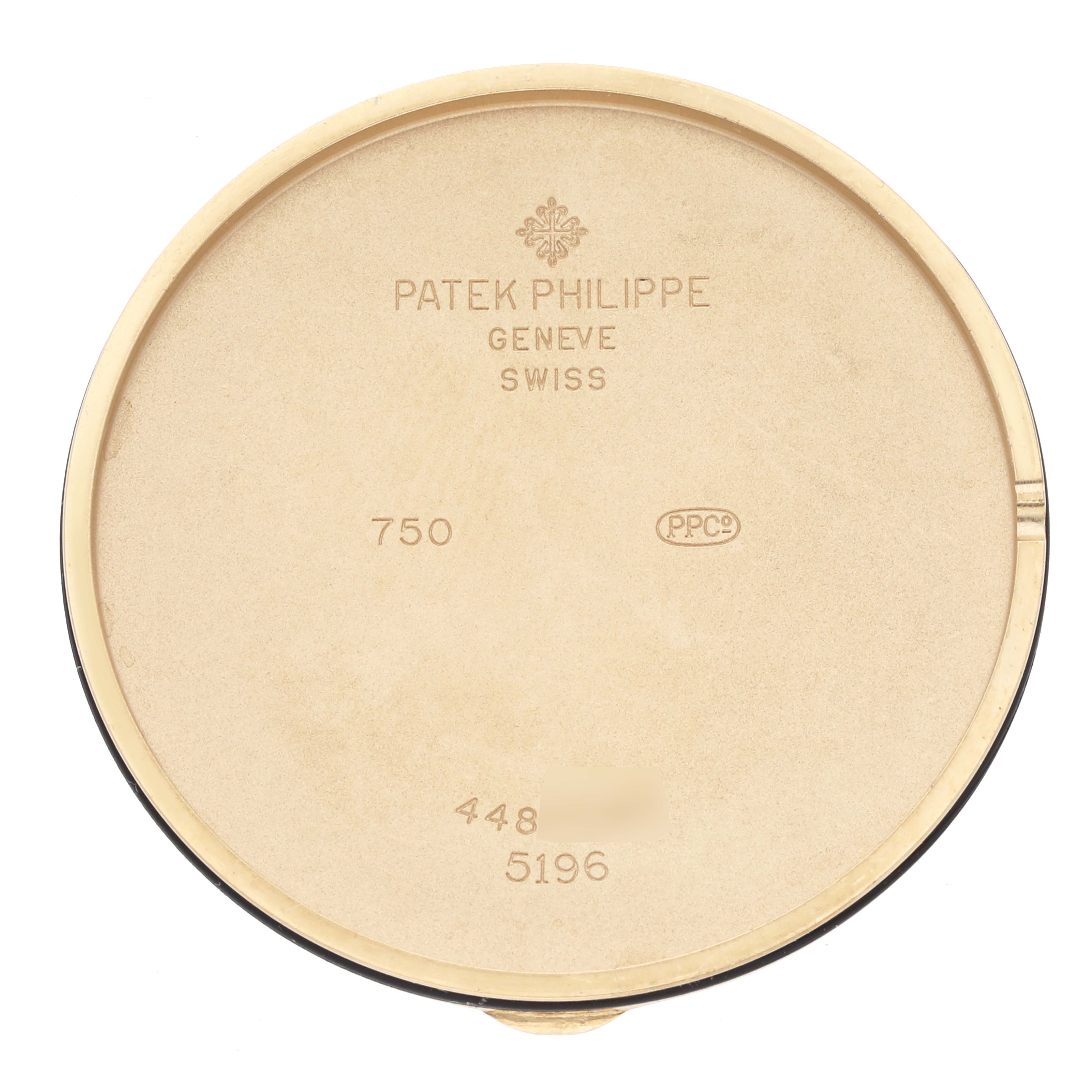 The image shows the inside of the case back of a Patek Philippe Calatrava 5196J-001 Men's Yellow Gold Silver Dial 5196J-001 Men's Yellow Gold Silver Dial watch, displaying engravings and hallmarks.