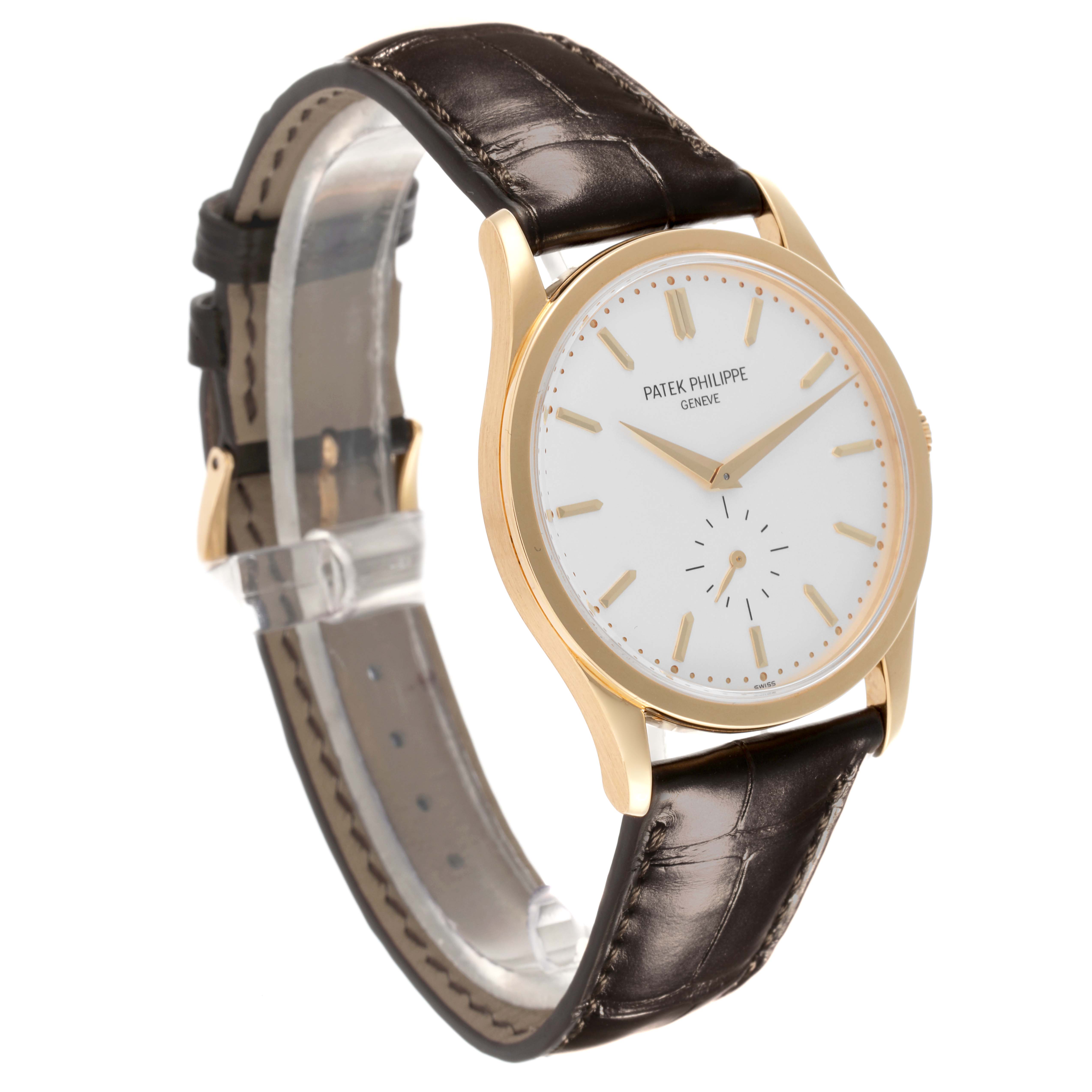 The Patek Philippe Calatrava 5196J-001 Men's Yellow Gold Silver Dial 5196J-001 Men's Yellow Gold Silver Dial watch is shown at a three-quarter angle, highlighting its gold case, white dial, and brown leather strap.