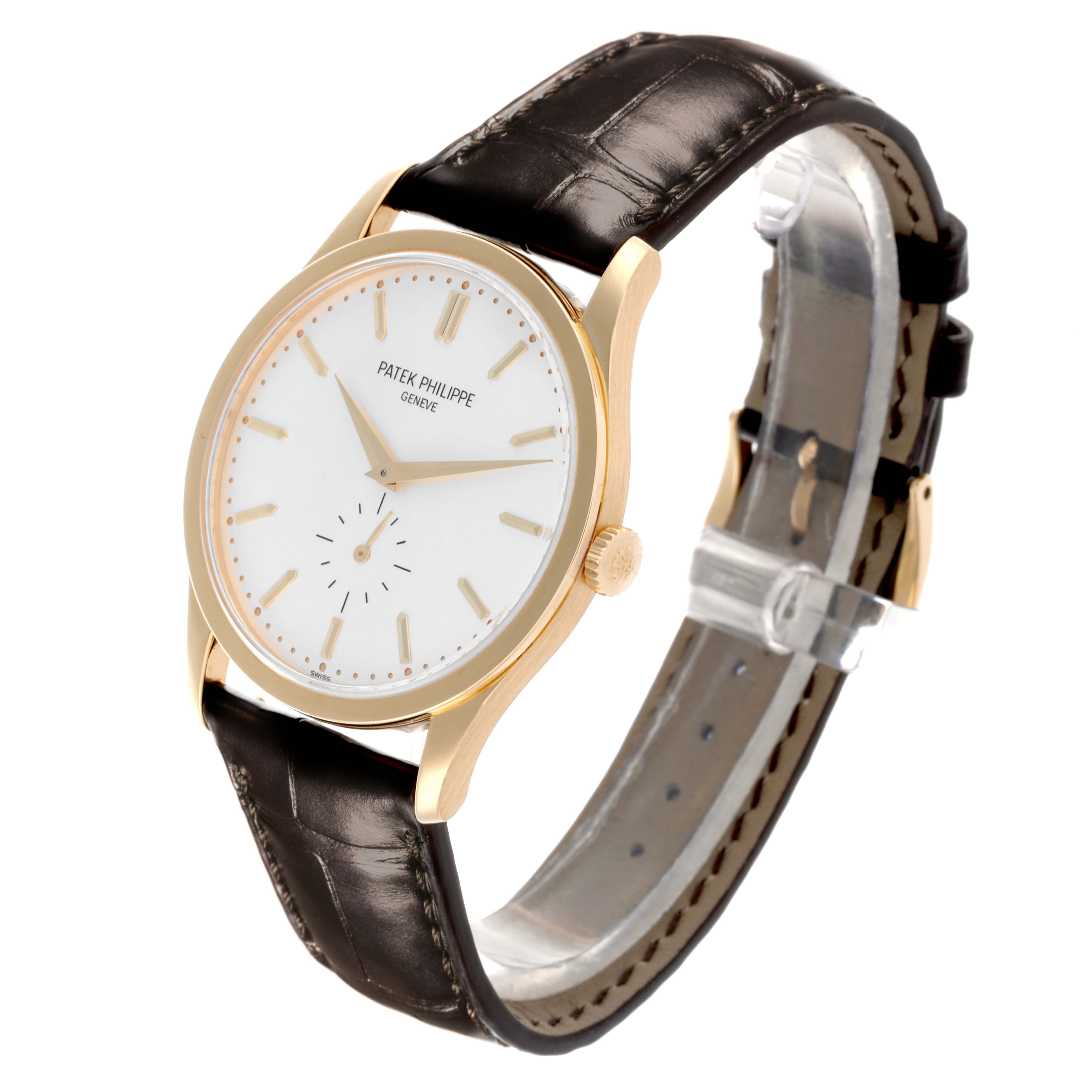 The Patek Philippe Calatrava 5196J-001 Men's Yellow Gold Silver Dial 5196J-001 Men's Yellow Gold Silver Dial watch is shown at a angled side view, displaying its dial, crown, strap, and buckle.