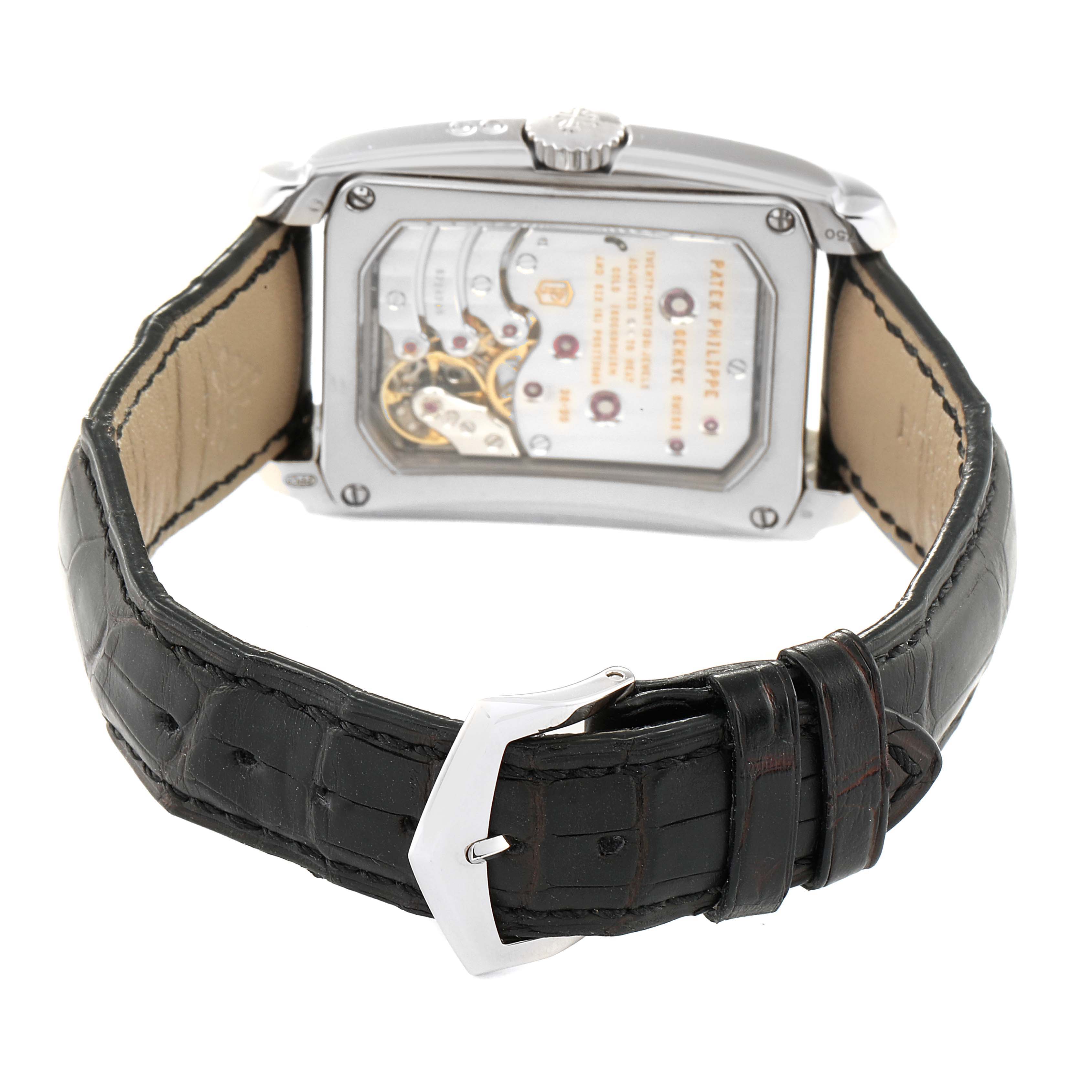 The image shows the back of the Patek Philippe Gondolo 5200G-010 Men's White Gold Silver Dial 5200G-010 Men's White Gold Silver Dial watch, highlighting its mechanical movement and black leather strap.
