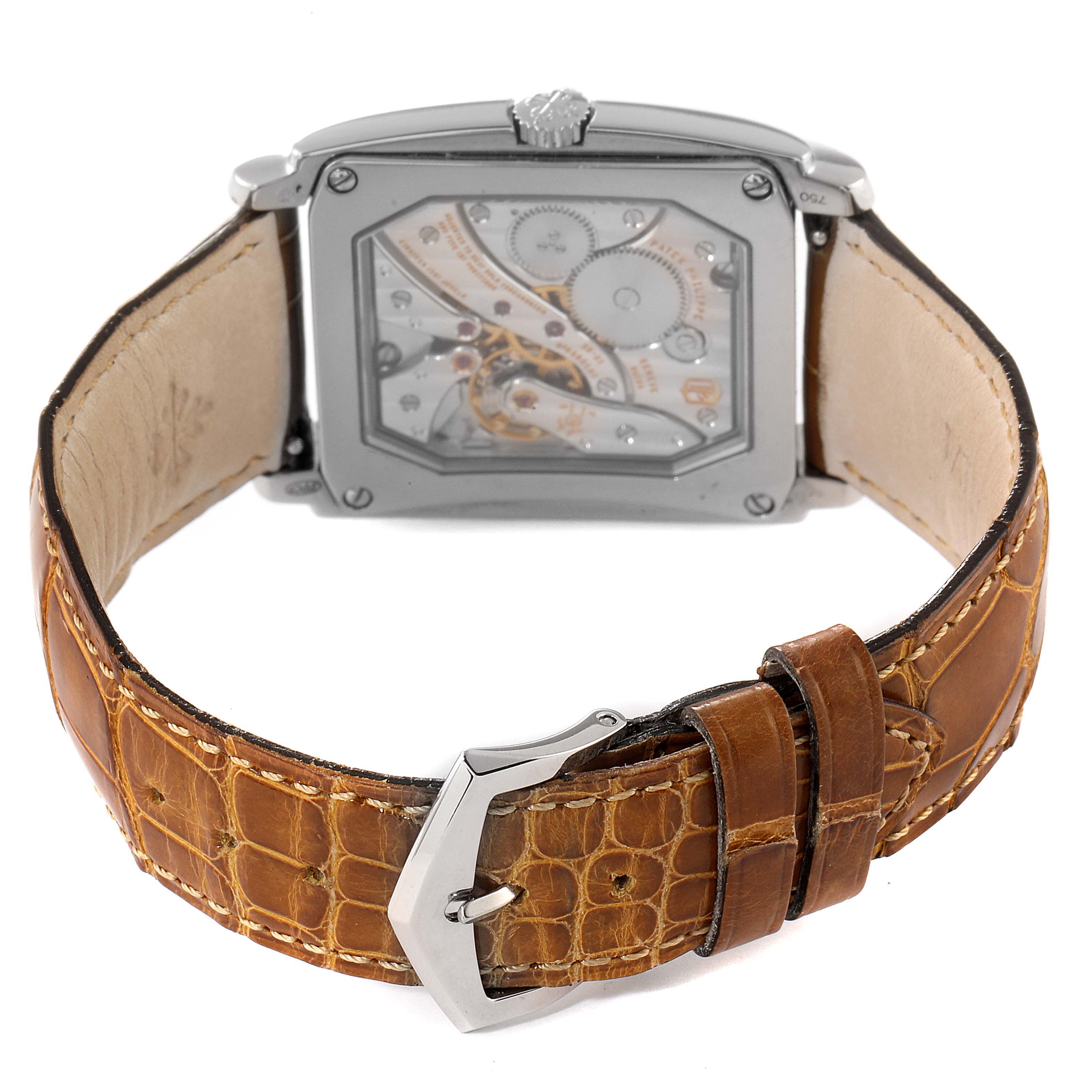 The image shows the back view of a Patek Philippe Gondolo 5124G Men's White Gold Pink Dial 5124G Men's White Gold Pink Dial watch, highlighting its mechanical movement and brown leather strap.