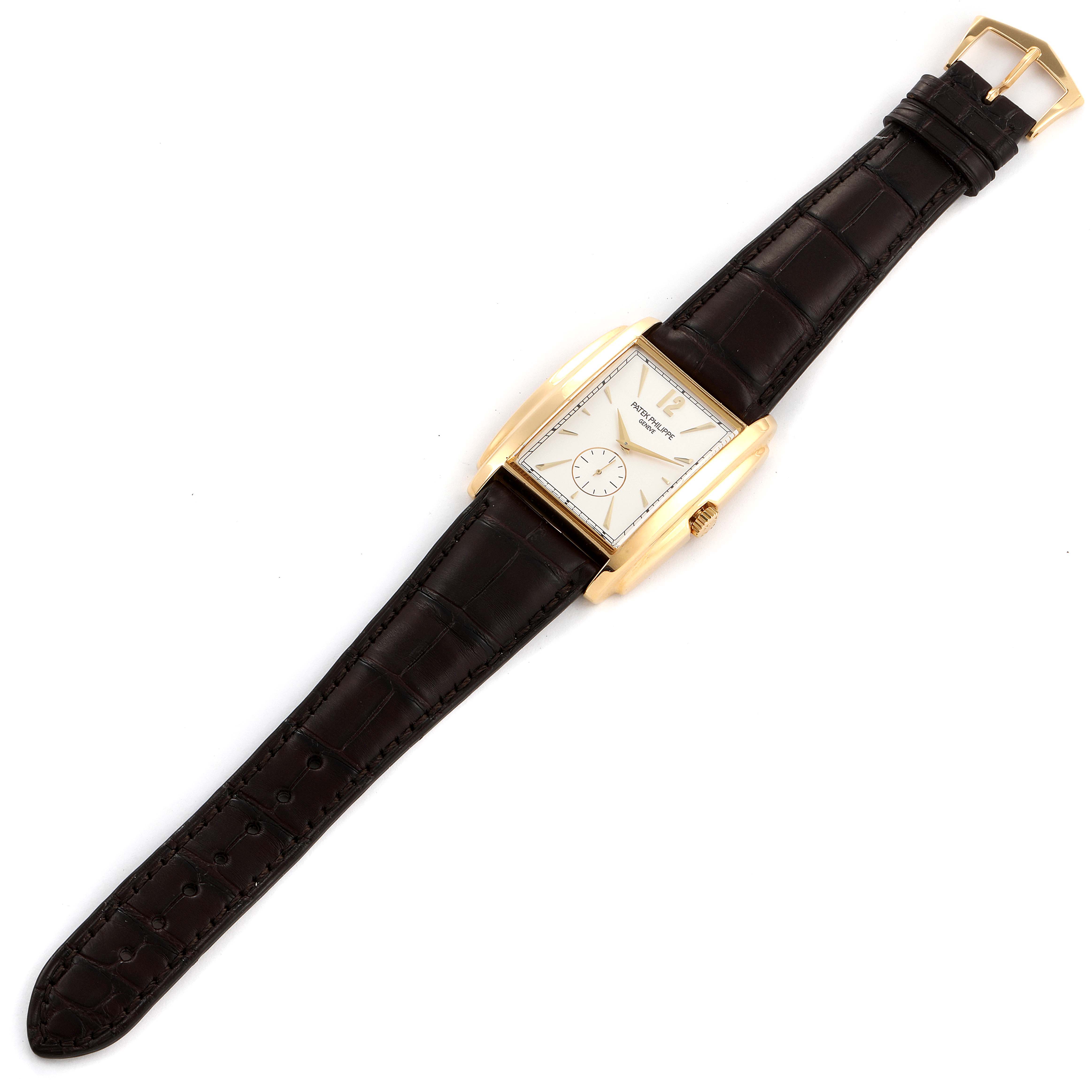 The Patek Philippe Gondolo 5124J Men's Yellow Gold Silver Dial 5124J Men's Yellow Gold Silver Dial watch is shown from a top-down angle, displaying the face, strap, and buckle.