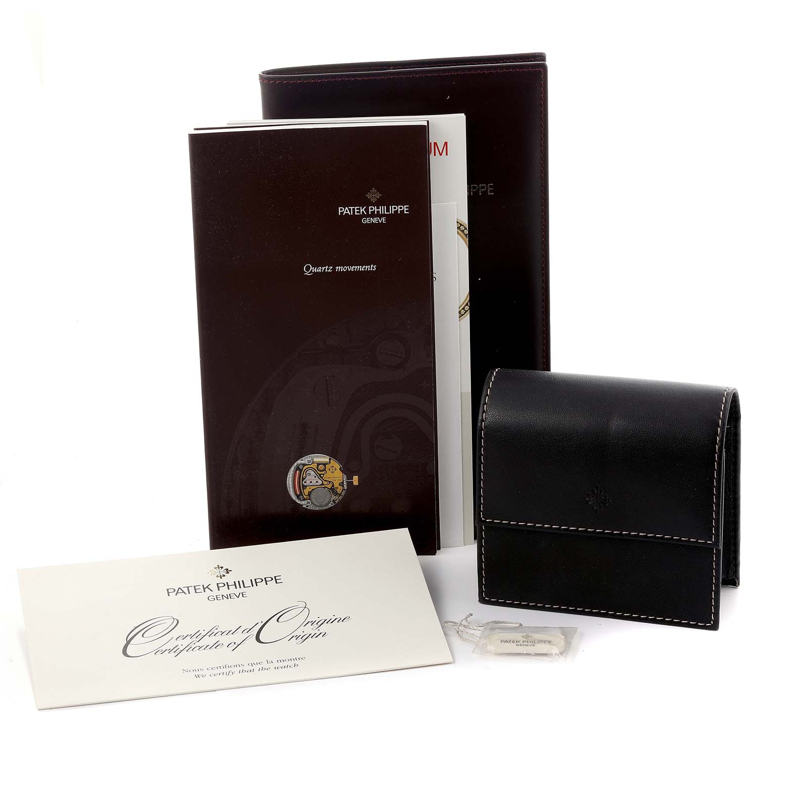 The image shows Patek Philippe Twenty-4 4910/10A-001 Women's Stainless Steel Black Dial 4910/10A-001 Women's Stainless Steel Black Dial model accessories, including a leather pouch, documentation, and a certificate.