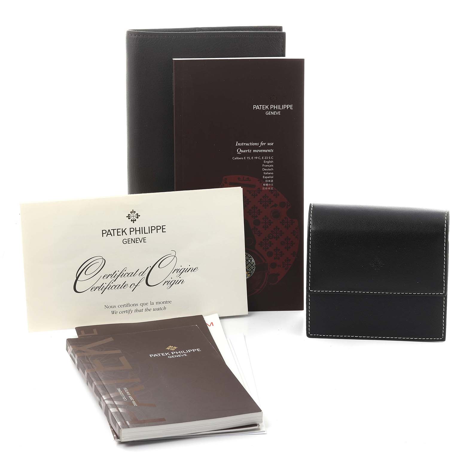 The image shows Patek Philippe Twenty-4 4910/10A-011 Women's Stainless Steel Silver Dial 4910/10A-011 Women's Stainless Steel Silver Dial accessories, including manuals, a certificate, and a black pouch, viewed from the front.