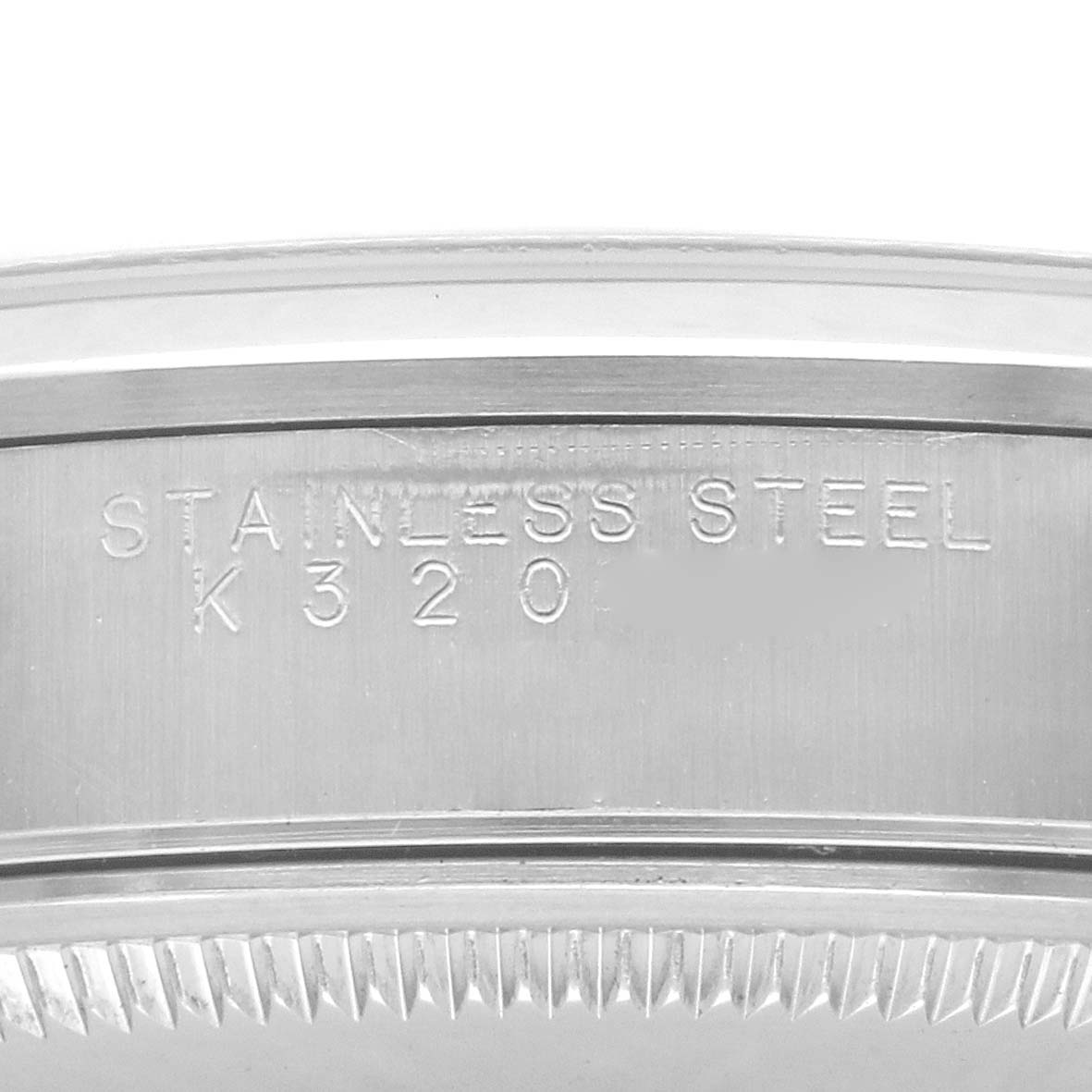 The image shows a close-up of the Rolex Air-King 14000 Men's Stainless Steel Blue Dial 14000 Men's Stainless Steel Blue Dial model's stainless steel watch case, focusing on the engraved text.