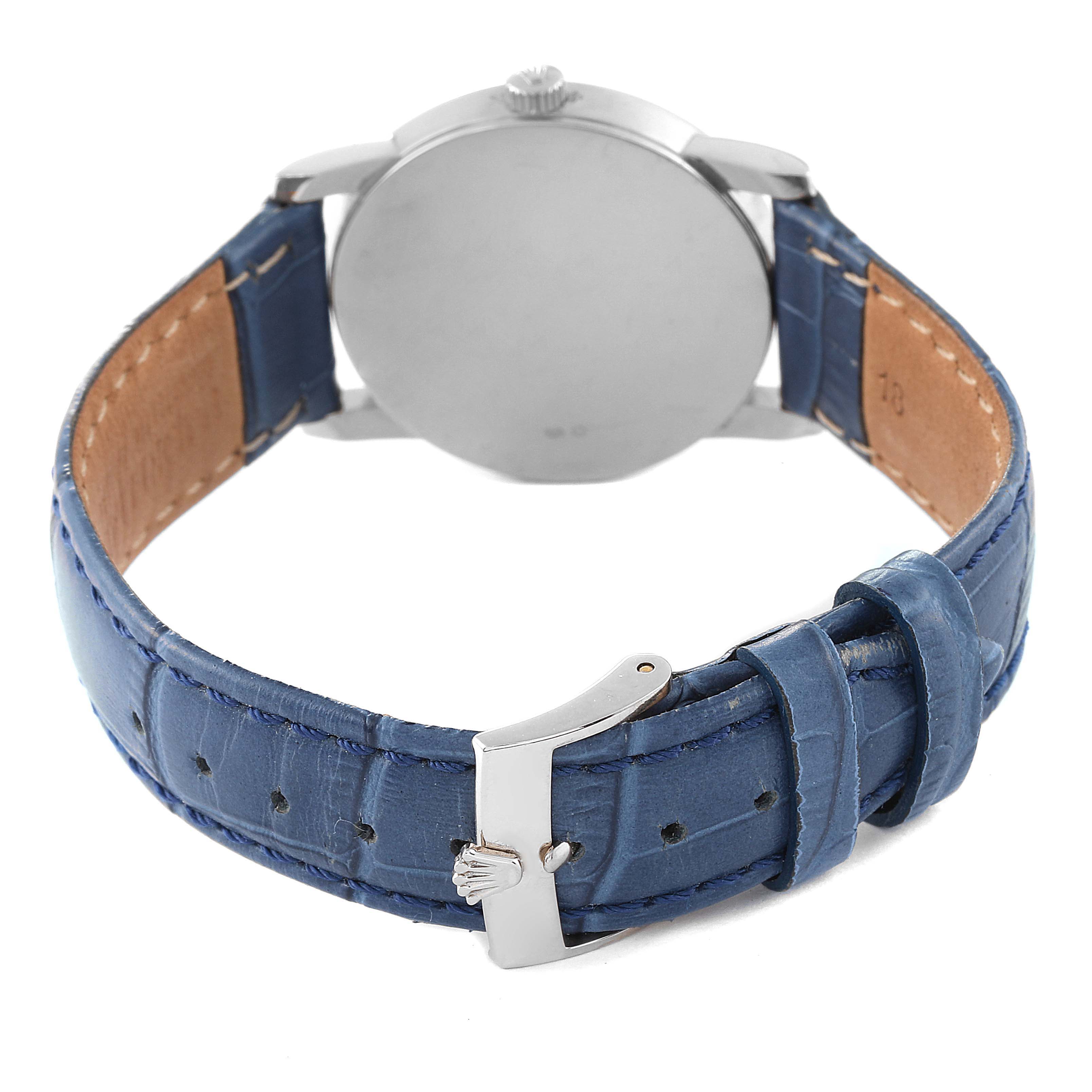 The image shows the back view of a Rolex Cellini 5116 Men's White Gold Silver Dial 5116 Men's White Gold Silver Dial watch, highlighting its blue leather strap and buckle.