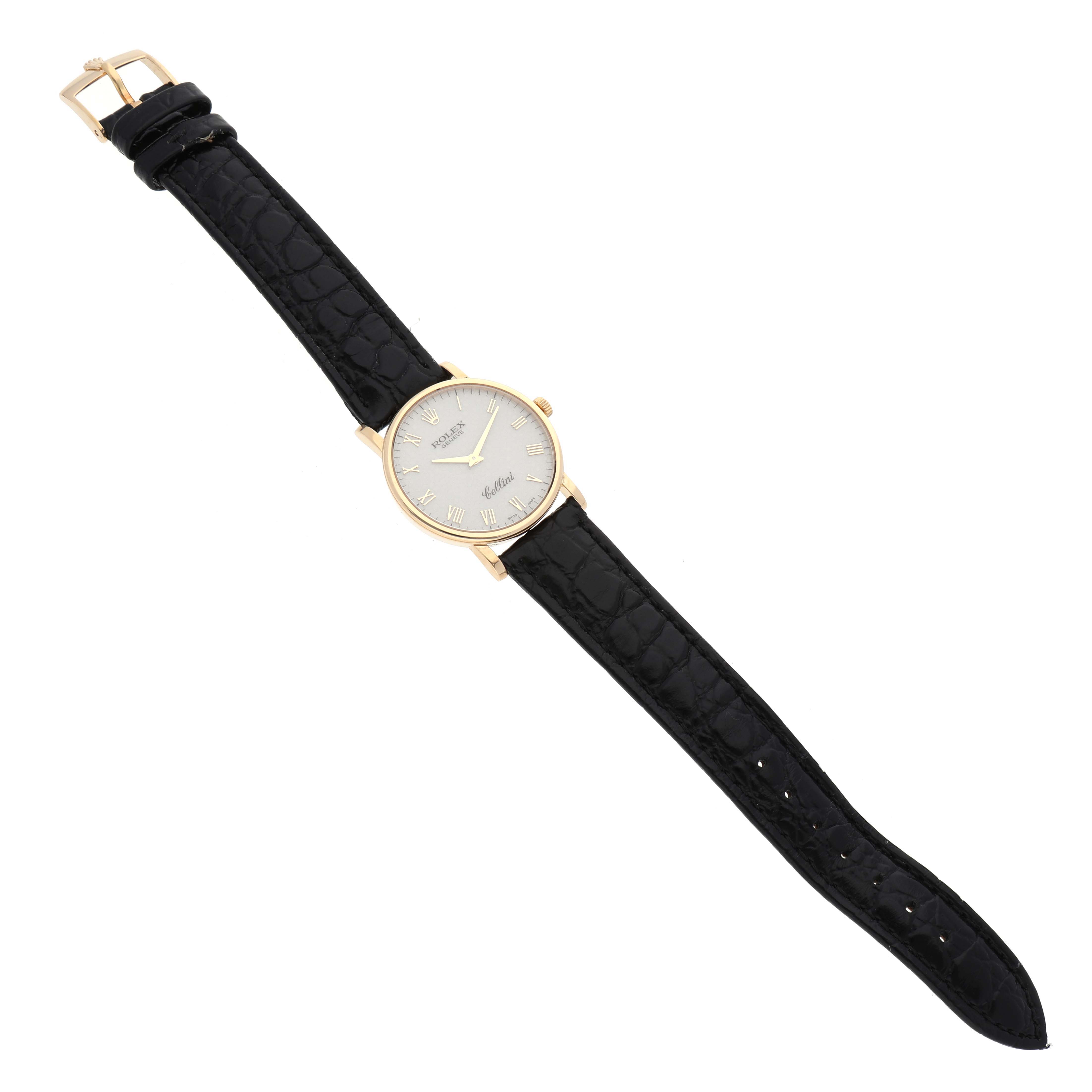 This image shows a Rolex Cellini 5115/8 Men's Yellow Gold White Dial 5115/8 Men's Yellow Gold White Dial watch from a top-down angle, featuring its gold case, white dial, and black leather strap.