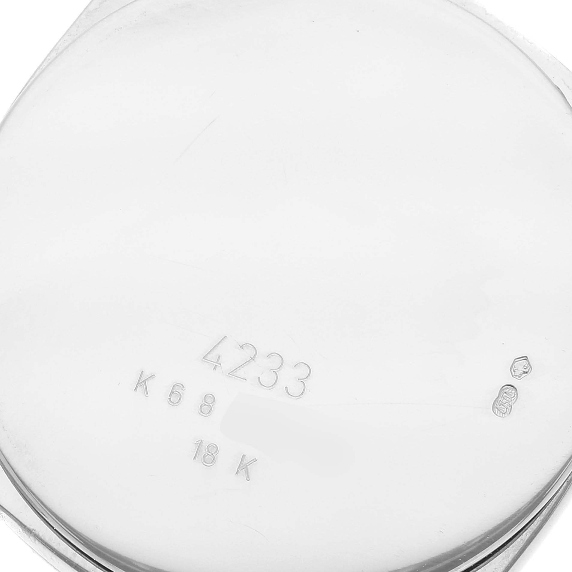 The image shows the case back of a Rolex Cellini 4233 Men
s White Gold Black Dial 4233 Men
s White Gold Black Dial model, featuring the model number and 18K gold marking.