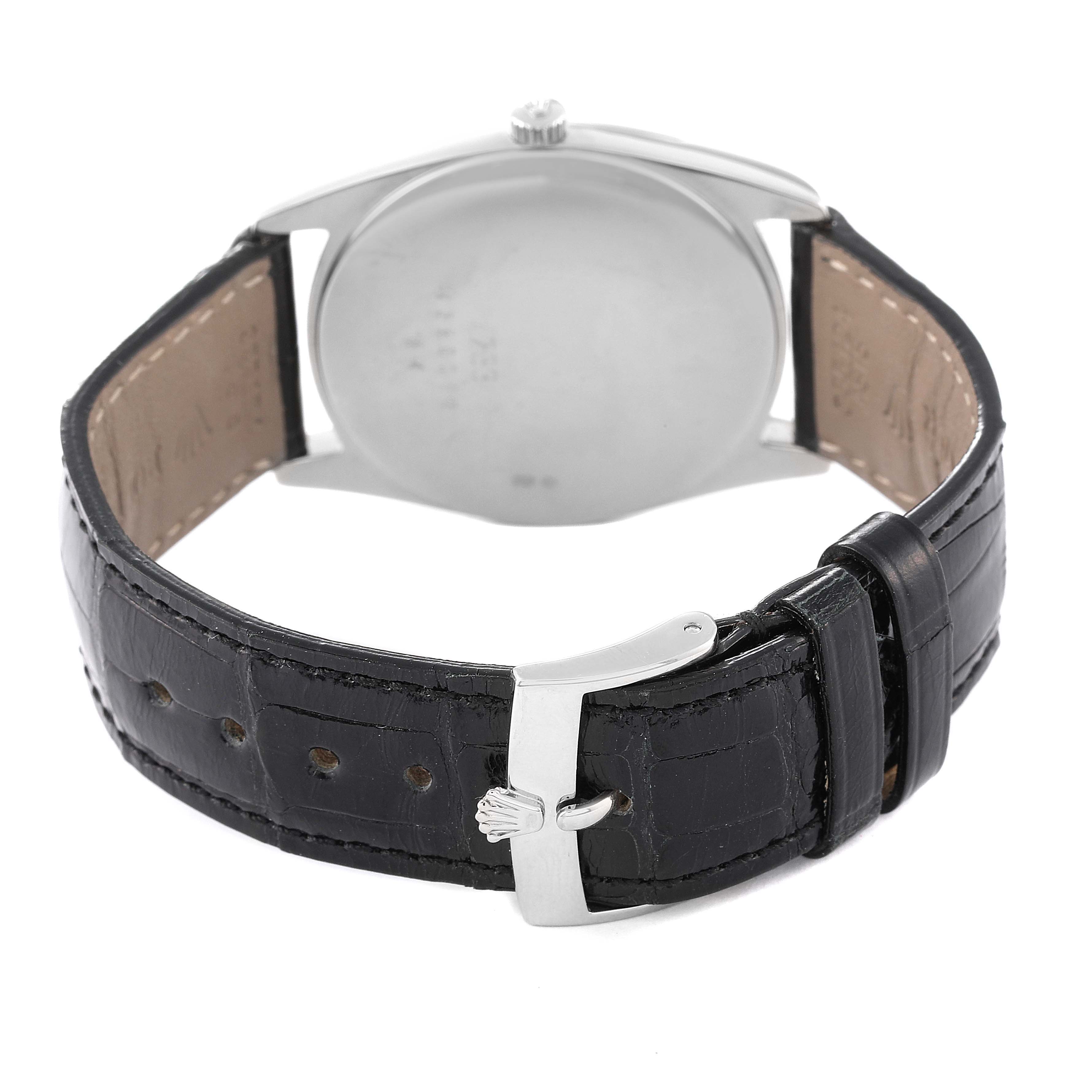The image shows the back view of a Rolex Cellini 4233 Men
s White Gold Black Dial 4233 Men
s White Gold Black Dial watch with its black leather strap and stainless steel clasp.