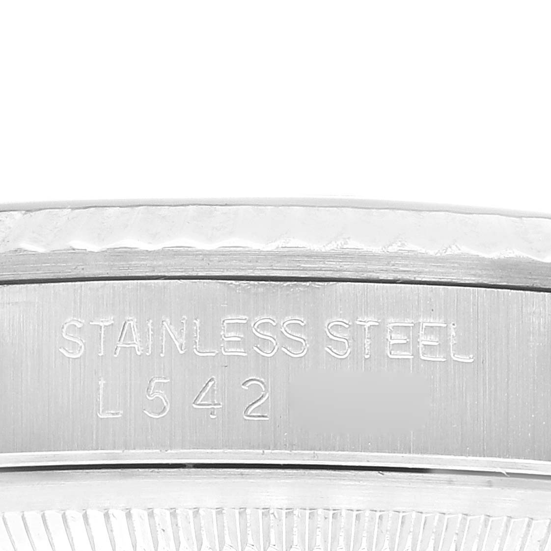 This image shows a close-up of the side engraving on a stainless steel Rolex Datejust 16234 Men's Stainless Steel Black Dial 16234 Men's Stainless Steel Black Dial watch, displaying the material and a number.