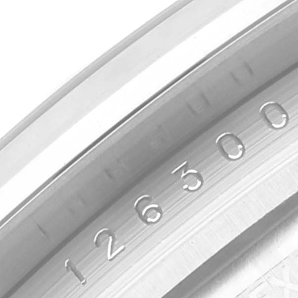 This image shows a close-up of the inside ring of a Rolex Datejust 41 126300 Men
s Stainless Steel Blue Dial 126300 Men
s Stainless Steel Blue Dial model, featuring part of the serial number engraving.