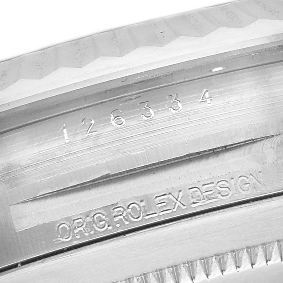 The image shows a close-up of the case side of a Rolex Datejust 41 126334 Men
s Stainless Steel Black Dial 126334 Men
s Stainless Steel Black Dial watch, revealing the model number and "ORIG ROLEX DESIGN" engraving.