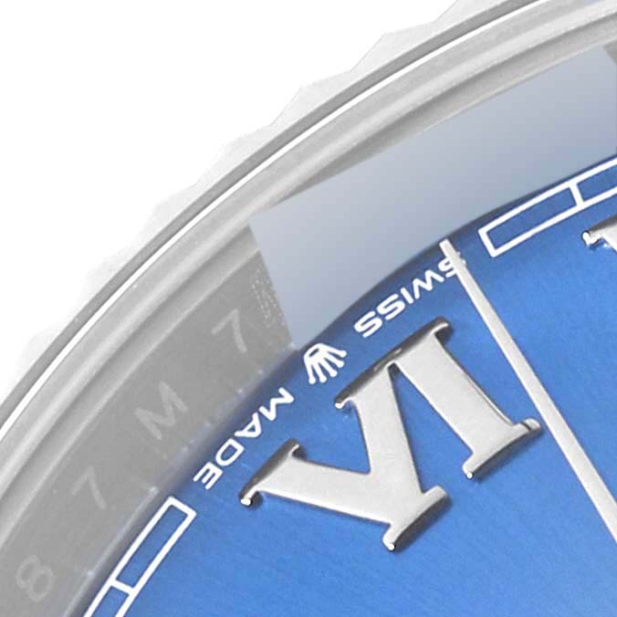 This close-up of a Rolex Datejust 41 126334 Men
s Stainless Steel Blue Dial 126334 Men
s Stainless Steel Blue Dial watch displays a partial view of the dial, showing the Roman numeral VI and the "Swiss Made" marking.