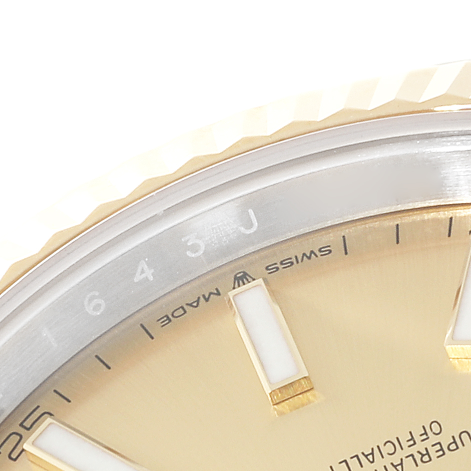 This close-up image shows a partial view of the Rolex Datejust 41 126333 Men's Steel and Gold (two tone) Champagne Dial 126333 Men's Steel and Gold (two tone) Champagne Dial's dial, bezel, and hour markers.