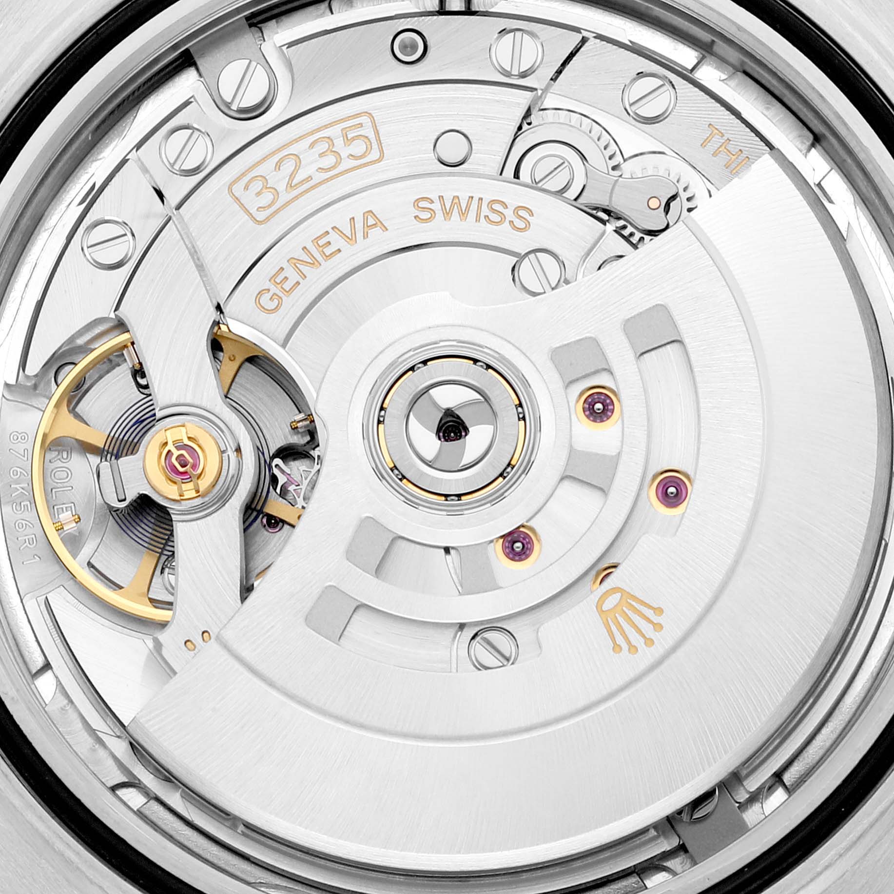 This is a close-up view of the movement inside a Rolex Datejust 41 126333 Men's Steel and Gold (two tone) Silver Dial 126333 Men's Steel and Gold (two tone) Silver Dial, showcasing the intricate components and inscriptions.