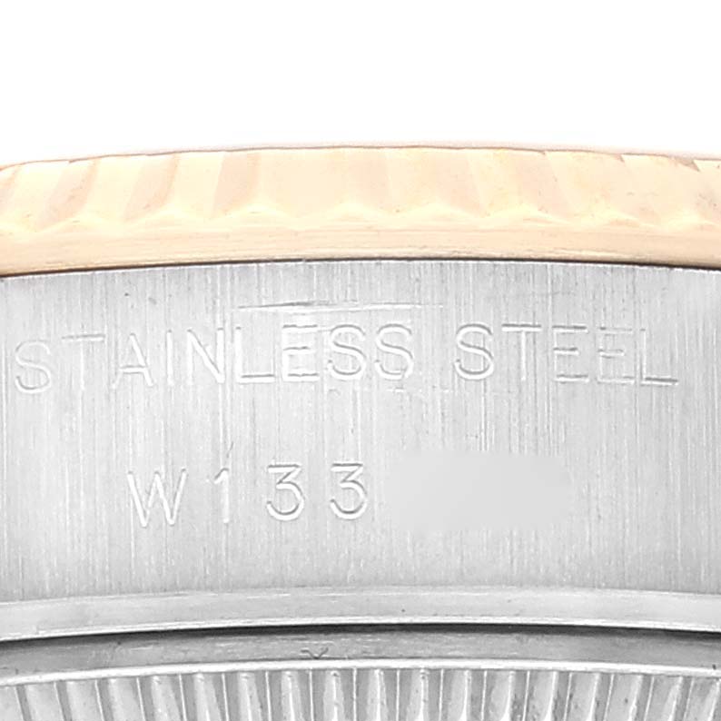 The image shows a close-up angle of the Rolex Datejust 69173 Women's Steel and Gold (two tone) Champagne Dial 69173 Women's Steel and Gold (two tone) Champagne Dial watch, focusing on the stainless steel case with engraved text.