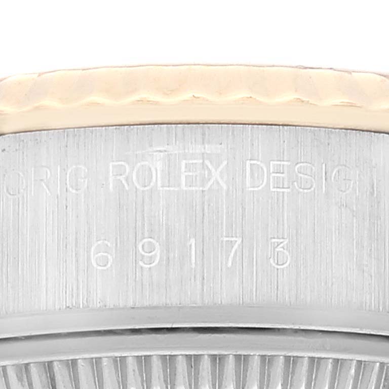 The image shows a close-up of the engraved case side of a Rolex Datejust 69173 Women's Steel and Gold (two tone) Champagne Dial 69173 Women's Steel and Gold (two tone) Champagne Dial, revealing the model number 6917.