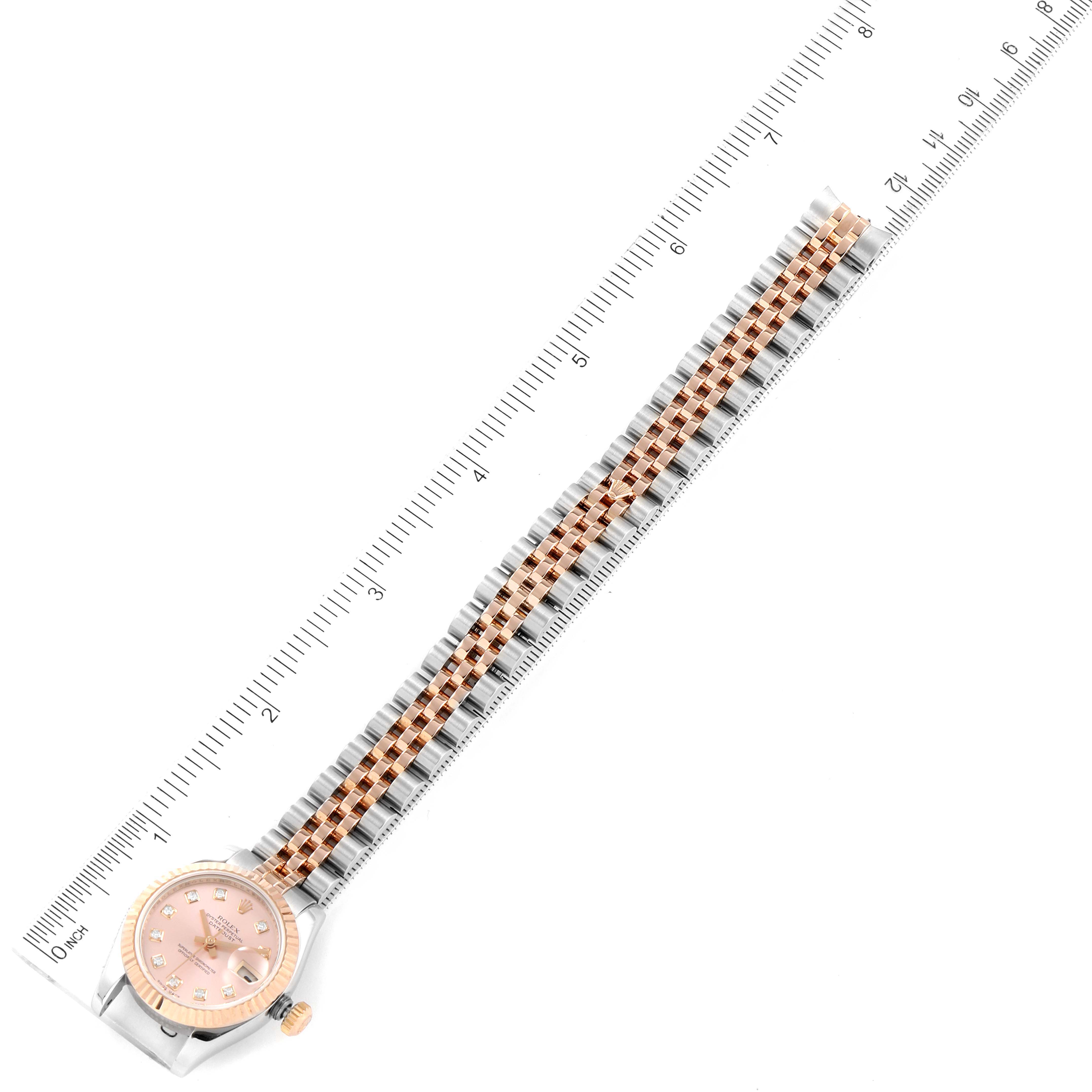 The image shows a Rolex Datejust 179171 Women's Steel and Gold (two tone) Pink Dial 179171 Women's Steel and Gold (two tone) Pink Dial watch lying flat with the face and entire band visible alongside a ruler for scale.