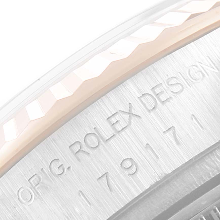 This close-up image shows the side engraving and fluted bezel of the Rolex Datejust 179171 Women's Steel and Gold (two tone) Pink Dial 179171 Women's Steel and Gold (two tone) Pink Dial model.