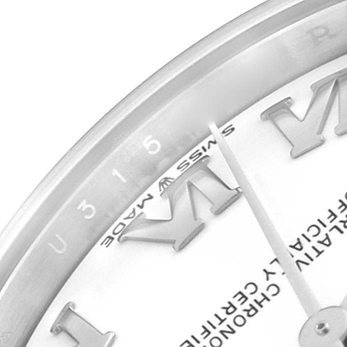 The close-up image of the Rolex Mid-Size 278274 Women
s Stainless Steel White Dial 278274 Women
s Stainless Steel White Dial watch shows the hour, minute hands, Roman numerals, and part of the bezel.