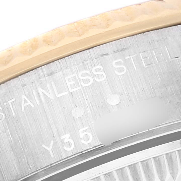 The image shows a close-up of the inscription on the case back of a Rolex Datejust 79173 Women's Steel and Gold (two tone) Mother of Pearl Dial 79173 Women's Steel and Gold (two tone) Mother of Pearl Dial watch, highlighting "STAINLESS STEEL" and a partial serial number.