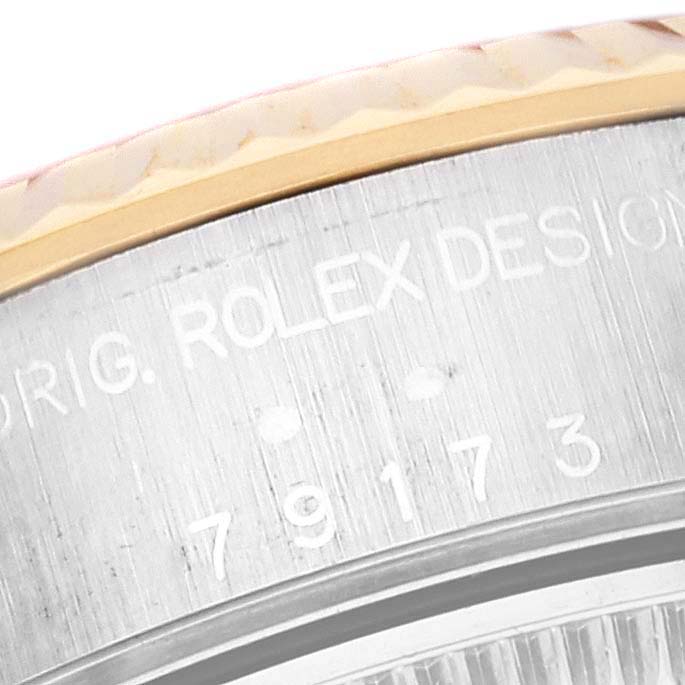 The image shows a close-up angle of the casing with engraving on a Rolex Datejust 79173 Women's Steel and Gold (two tone) Mother of Pearl Dial 79173 Women's Steel and Gold (two tone) Mother of Pearl Dial watch.
