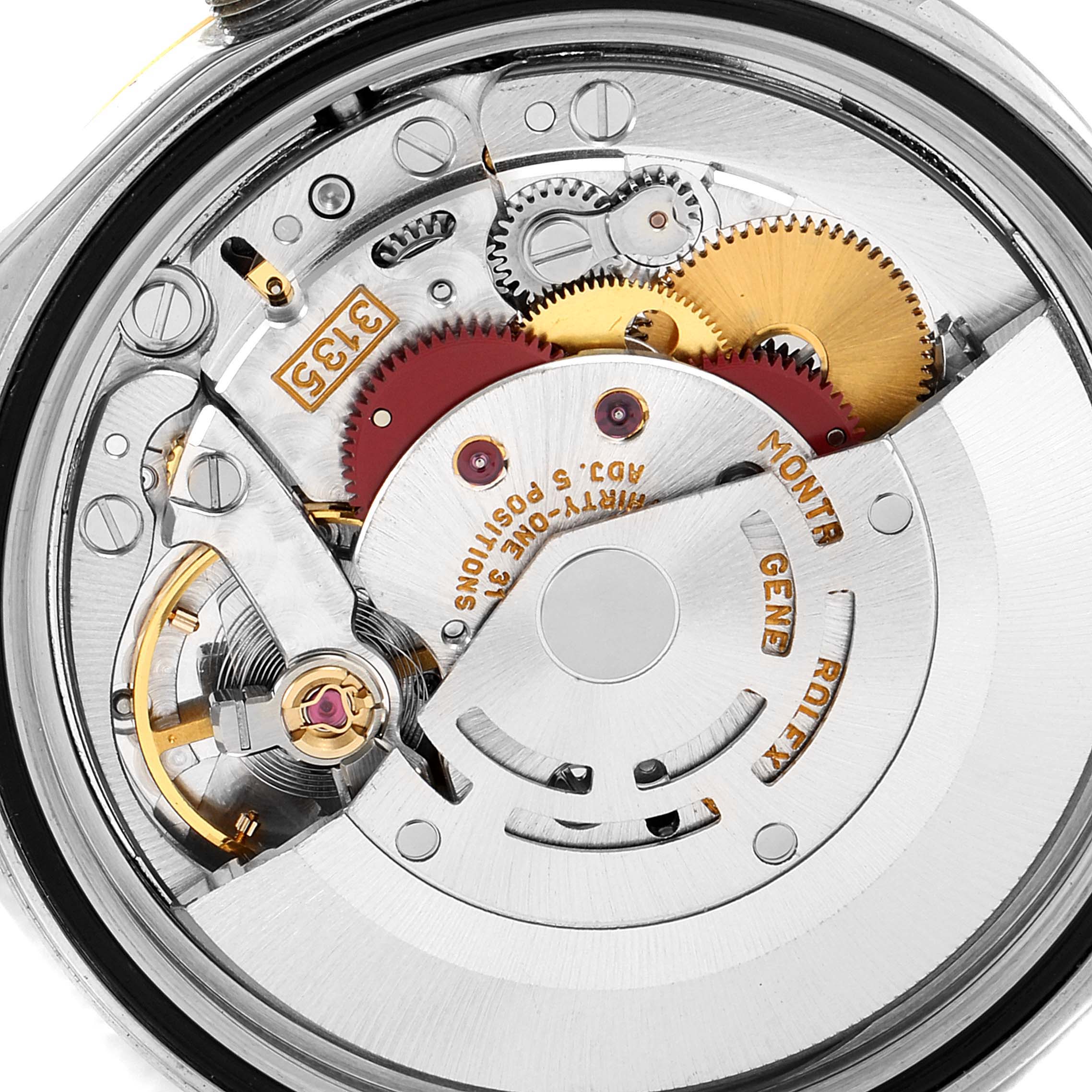 This is an internal view of the Rolex Datejust 16233 Men's Steel and Gold (two tone) Blue Dial 16233 Men's Steel and Gold (two tone) Blue Dial watch, showcasing its movement and intricate gears.