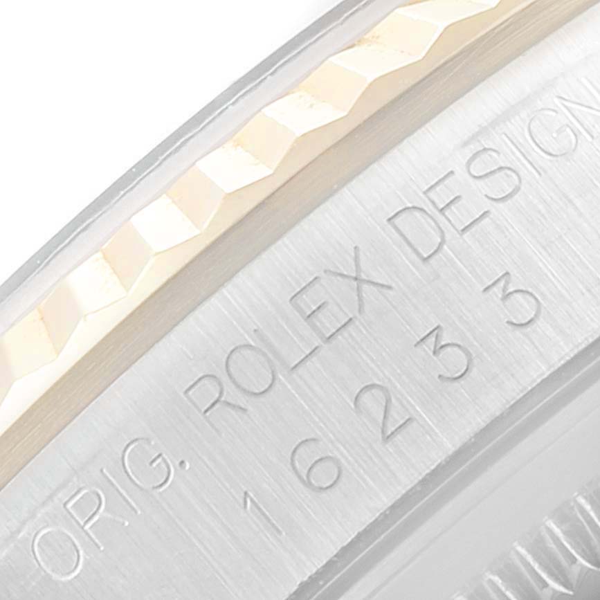 This close-up image shows the engraved side of the case of a Rolex Datejust 16233 Men's Steel and Gold (two tone) Blue Dial 16233 Men's Steel and Gold (two tone) Blue Dial model.