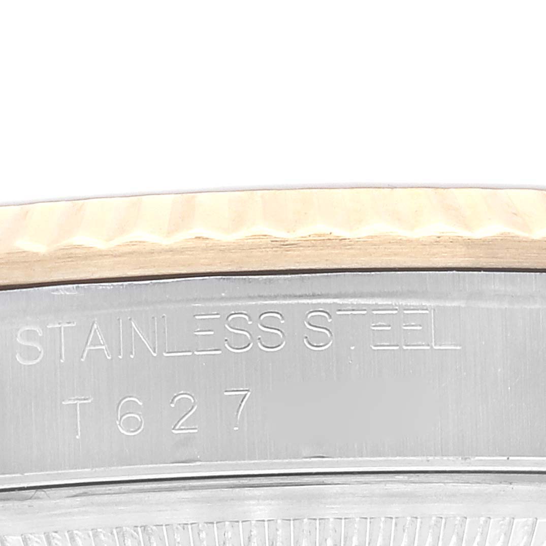 This close-up shows the side angle of a Rolex Datejust 16233 Men's Steel and Gold (two tone) Champagne Dial 16233 Men's Steel and Gold (two tone) Champagne Dial's case, displaying engraved text and part of the bezel.