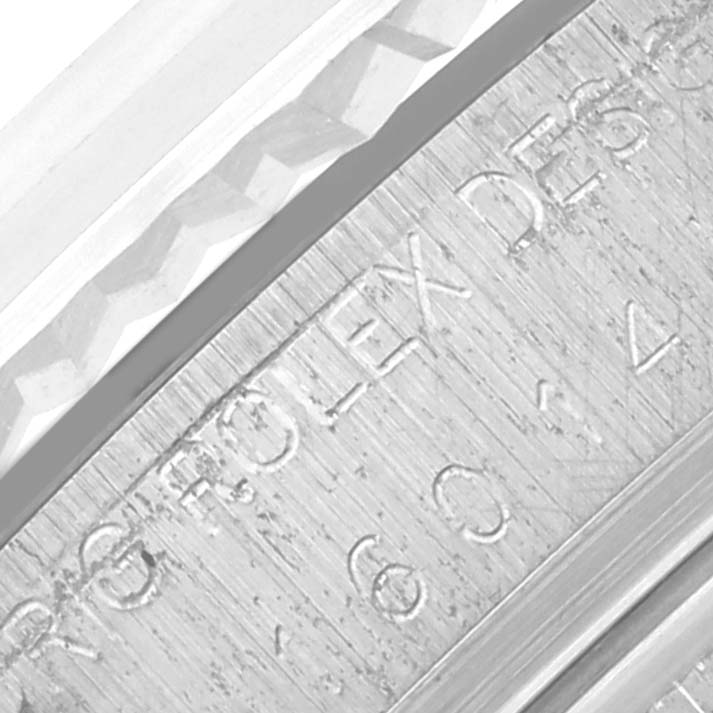 The image shows a close-up angle of the Rolex Datejust 16014 Men
s Stainless Steel Silver Dial 16014 Men
s Stainless Steel Silver Dial
s inner bezel, displaying engraved text.