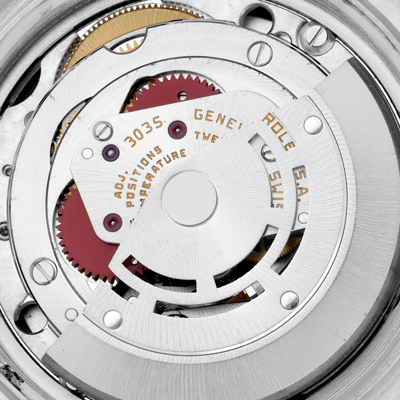 The image shows an overhead view of the inner movement of a Vintage Collection model by Rolex, highlighting gears and the rotor.