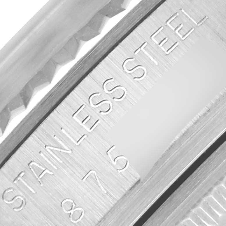 The image shows a close-up of the metal bezel and engraved "STAINLESS STEEL" on the Vintage Collection model by Rolex.