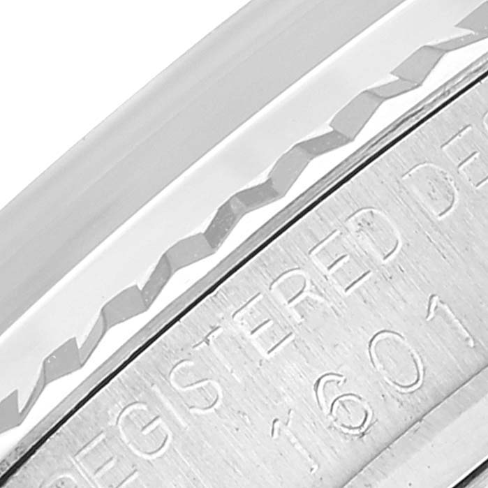 This close-up image shows a partial view of the case and bezel with engraved text on the Rolex Vintage Collection 1601 Men
s Stainless Steel Silver Dial 1601 Men
s Stainless Steel Silver Dial model.