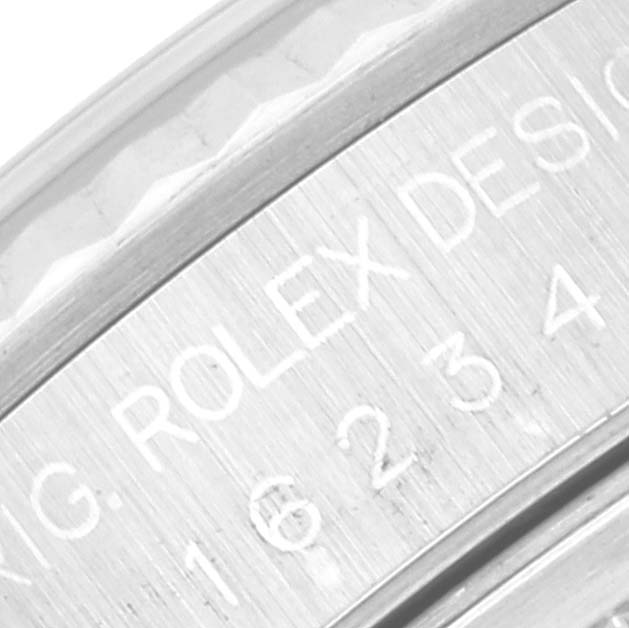 The image shows a close-up of the engraving on the bezel and case of a Rolex Datejust 16234 Men's Stainless Steel Silver Dial 16234 Men's Stainless Steel Silver Dial watch.