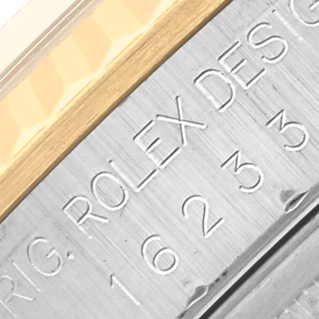 The image shows a close-up of the bezel and engraved markings on the side of a Rolex Datejust 16233 Men
s Steel and Gold (two tone) Black Dial 16233 Men
s Steel and Gold (two tone) Black Dial watch.