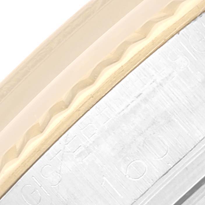 This close-up image shows part of the bezel and case components of the Rolex Vintage Collection 1601 Men's Steel and Gold (two tone) Blue Dial 1601 Men's Steel and Gold (two tone) Blue Dial watch.