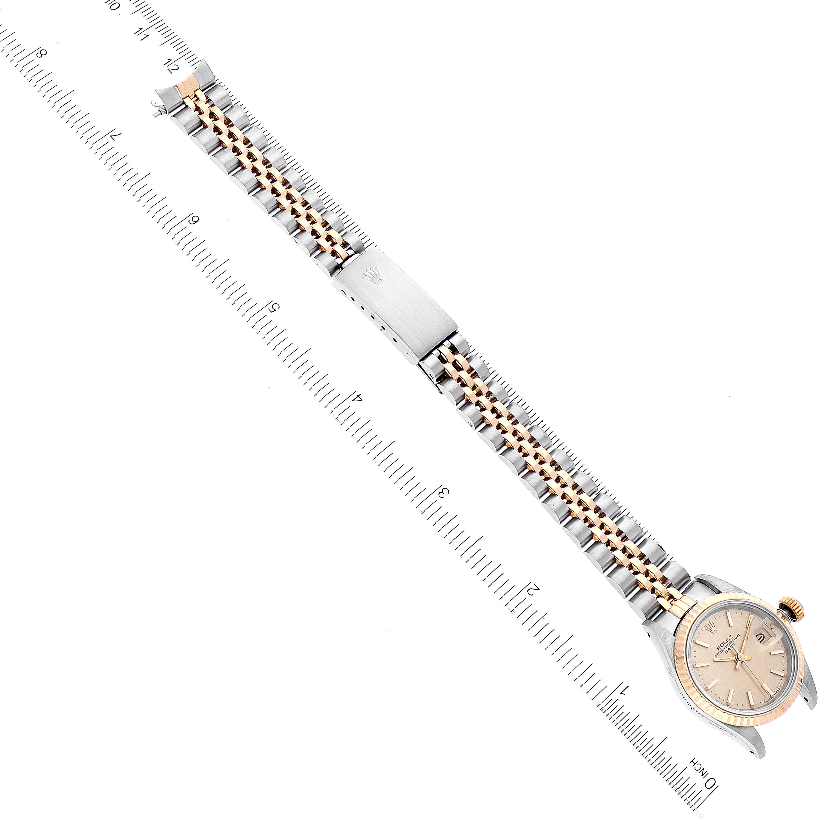 The Rolex Datejust 69173 Women's Steel and Gold (two tone) Champagne Dial 69173 Women's Steel and Gold (two tone) Champagne Dial watch is shown from a top view, focusing on the full bracelet, clasp, and watch face.