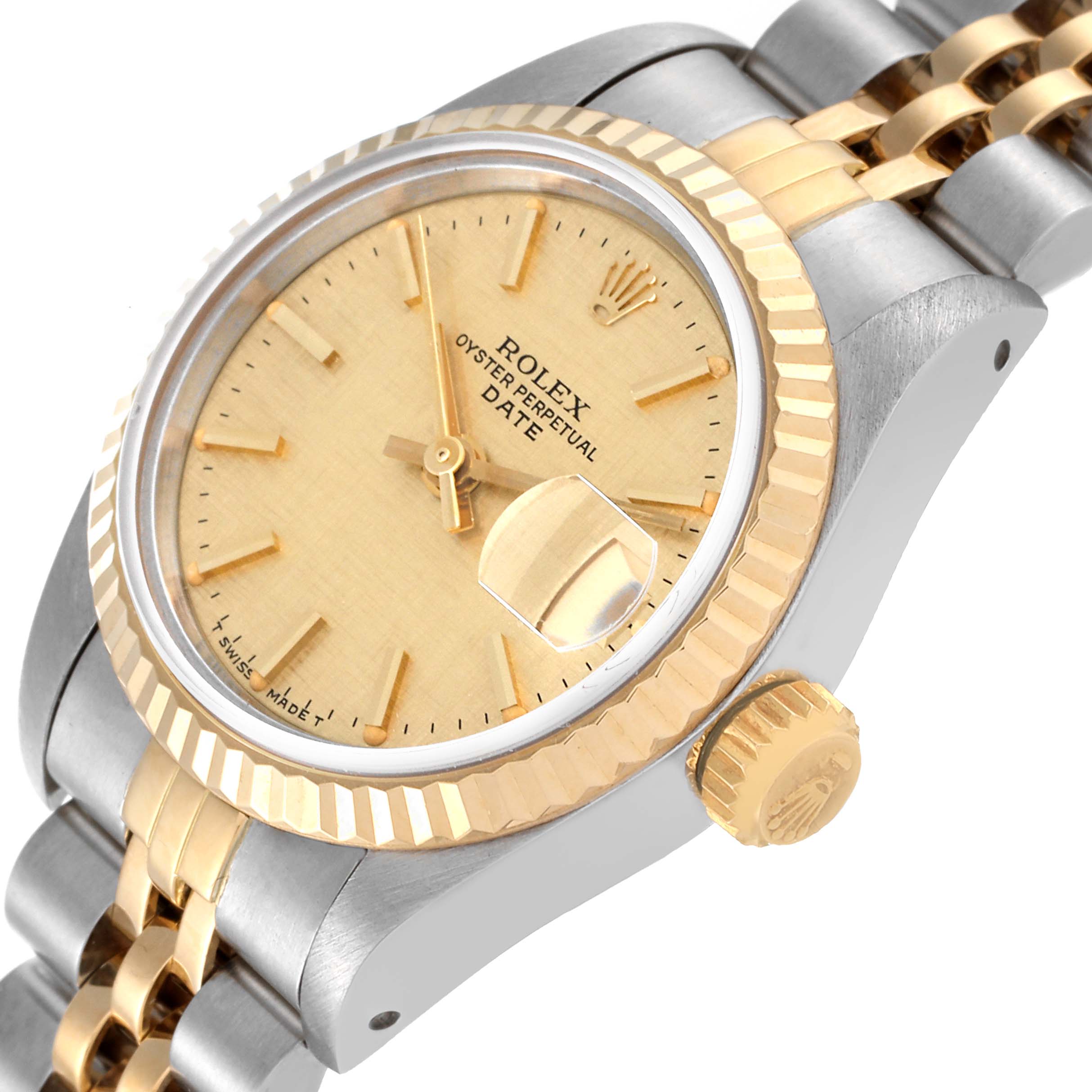 This image shows a close-up of the Rolex Datejust 69173 Women's Steel and Gold (two tone) Champagne Dial 69173 Women's Steel and Gold (two tone) Champagne Dial watch face, crown, bezel, and part of the bracelet at an angle.