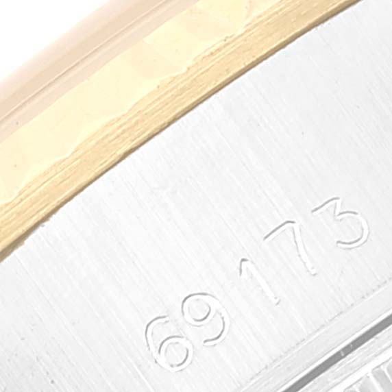 This close-up image shows the side of the Rolex Datejust 69173 Women's Steel and Gold (two tone) Champagne Dial 69173 Women's Steel and Gold (two tone) Champagne Dial watch case, displaying part of the serial number.
