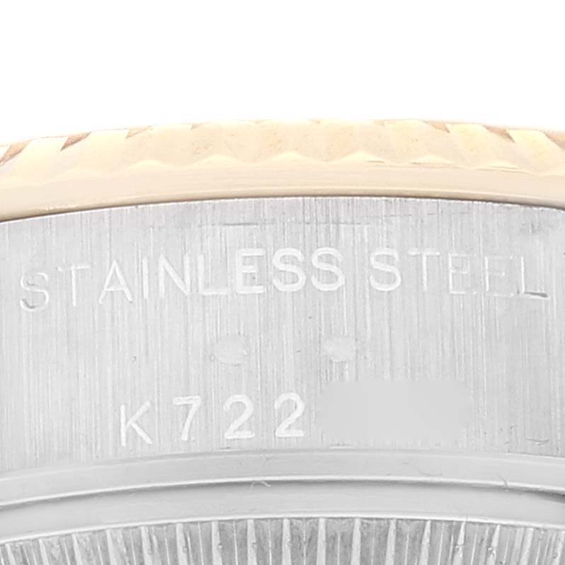 The image shows a close-up of the case back and part of the bezel of a Rolex Datejust 79173 Women's Steel and Gold (two tone) Champagne Dial 79173 Women's Steel and Gold (two tone) Champagne Dial watch, highlighting the stainless steel casing and serial number.