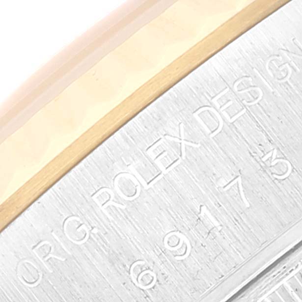 This image shows a close-up view of the engraved case side of a Rolex Datejust 69173 Women's Steel and Gold (two tone) Beige Dial 69173 Women's Steel and Gold (two tone) Beige Dial watch, focusing on the serial number and brand engraving.