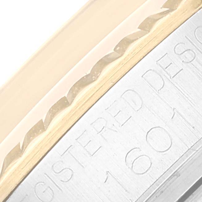 The image shows a close-up of the engraved case edge and fluted bezel of a Rolex Vintage Collection 1601 Men's Steel and Gold (two tone) Silver Dial 1601 Men's Steel and Gold (two tone) Silver Dial model.