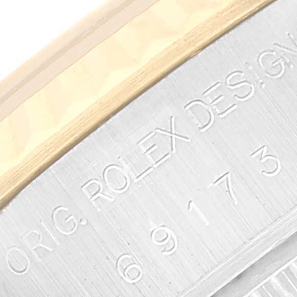 Close-up of the engraved side casing of a Rolex Datejust 69173 Women's Steel and Gold (two tone) White Dial 69173 Women's Steel and Gold (two tone) White Dial watch, showcasing text details.