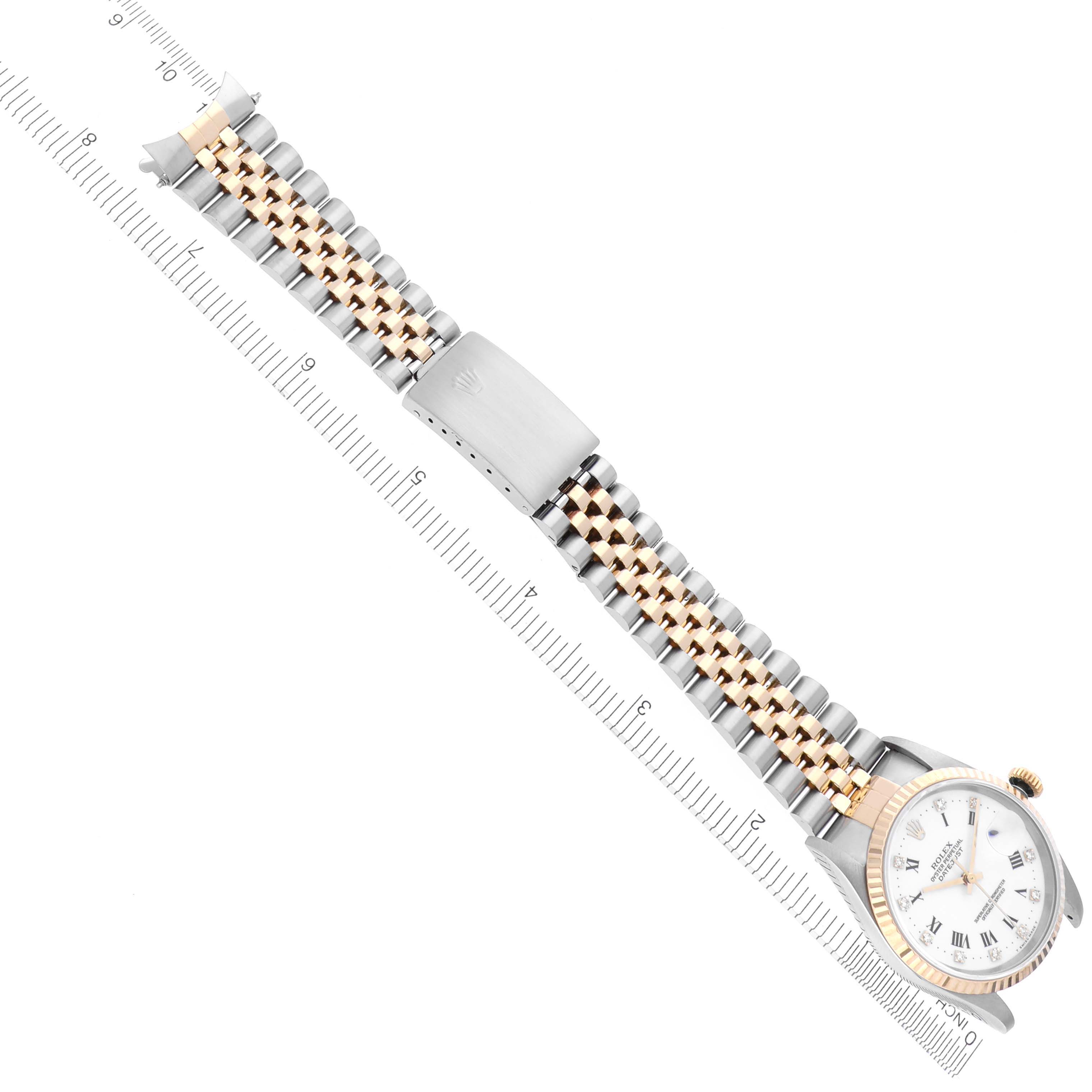 The image shows a top-down view of a Rolex Datejust 16233 Men's Steel and Gold (two tone) White Dial 16233 Men's Steel and Gold (two tone) White Dial watch with focus on the bracelet and clasp, alongside a ruler.